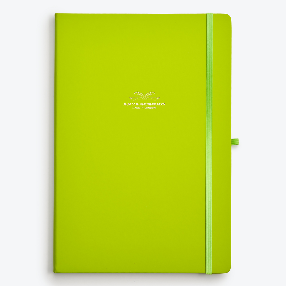 A green A4 hardback refill notepad with a matching elastic pen holder and a ribbon bookmark, branded with Anya Sushko logo in gold foil on the cover.