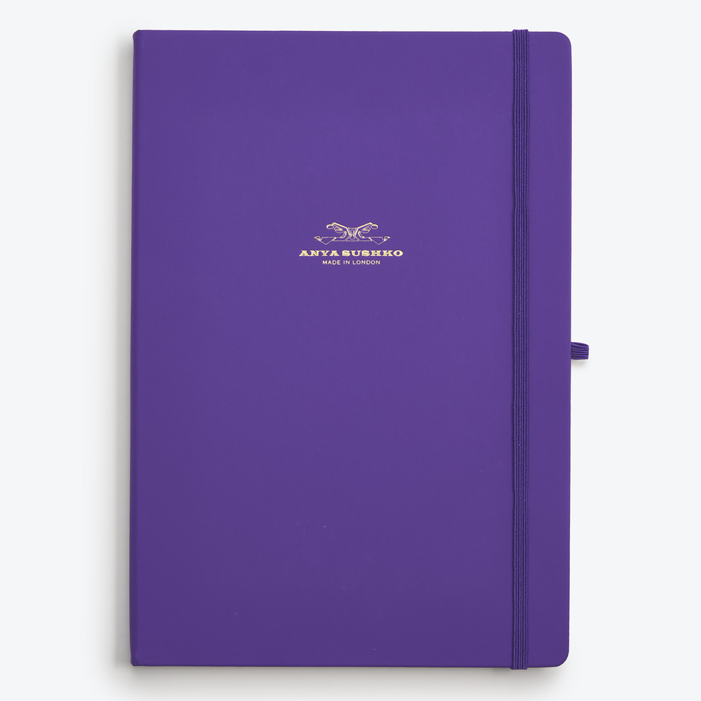 A purple A4-sized hardback refill notepad with a gold embossed logo of Anya Sushko on the cover.