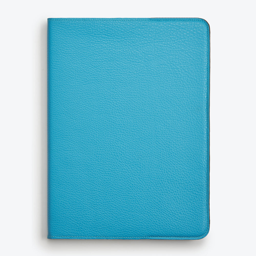 A Turquoise Luxury leather notepad with a hardcover.